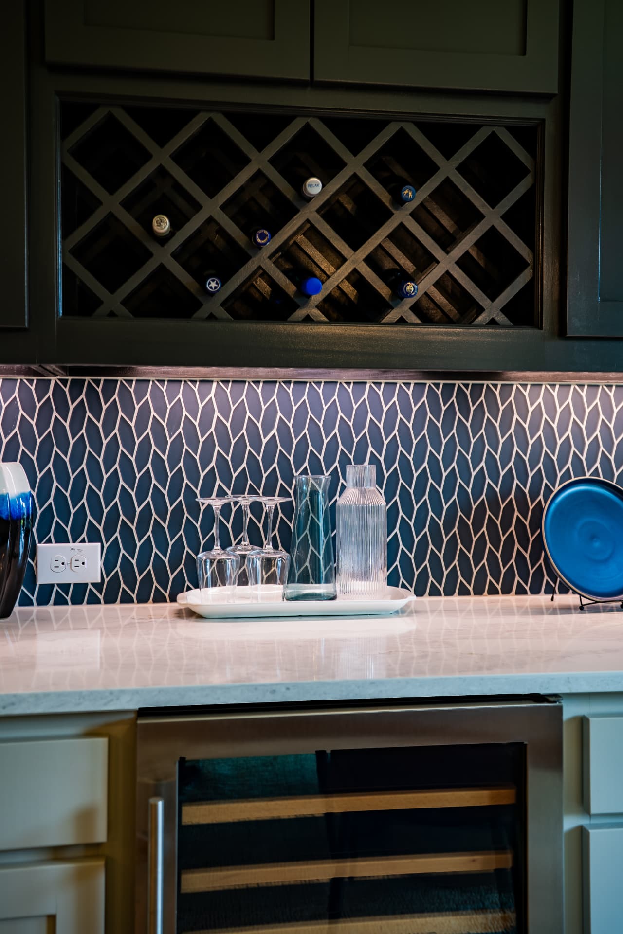 Wet bar with wine storage and patterned tile backsplash